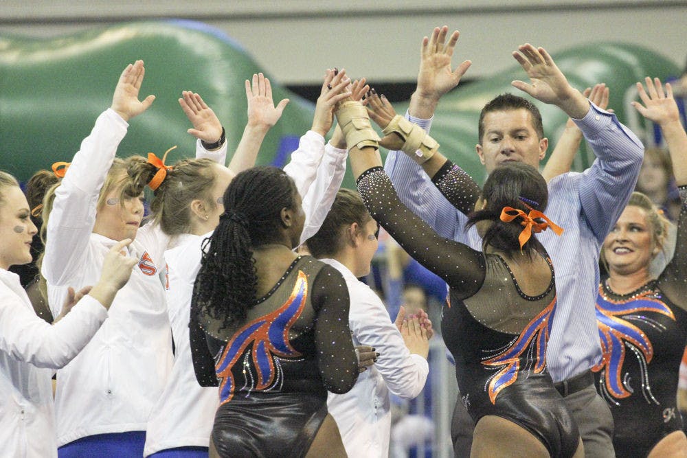 Adrian Burde celebrates with Florida gymnasts during UF's loss to LSU on Feb. 26, 2016, in the O'Connell Center.