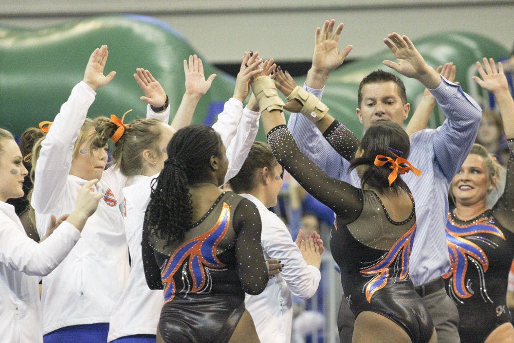<p>Adrian Burde celebrates with Florida gymnasts during UF's loss to LSU on Feb. 26, 2016, in the O'Connell Center.</p>