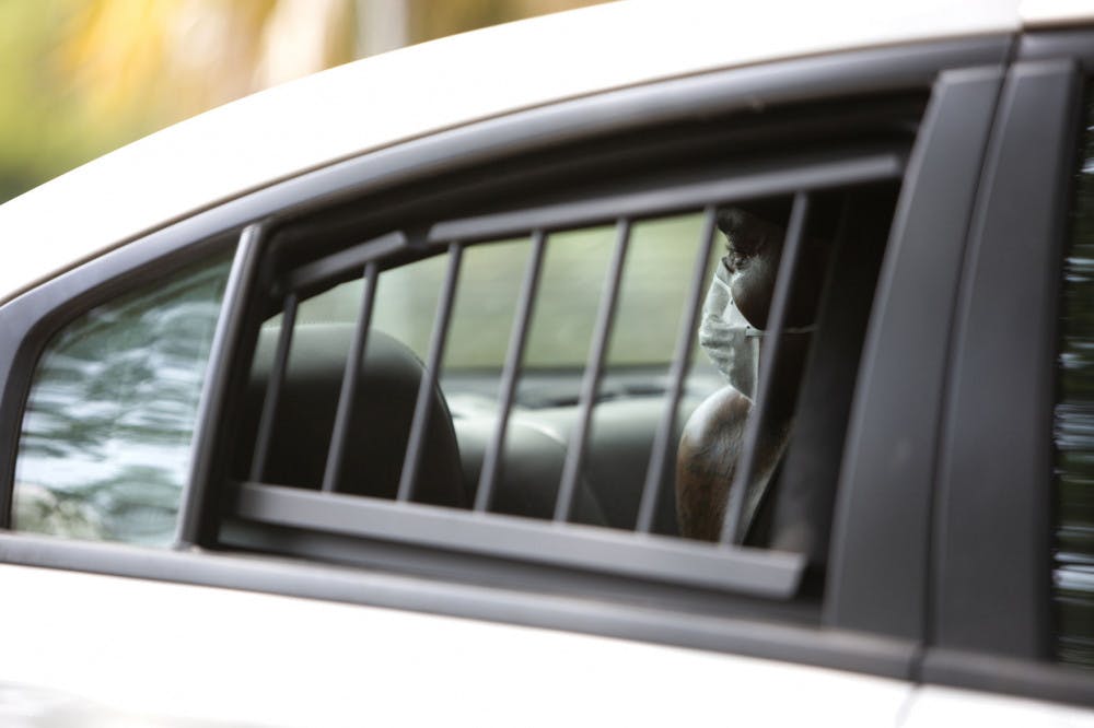 Allen Strawder, 31, is arrested by Gainesville Police Department officers on April 8, 2020, in downtown Gainesville&nbsp;and is accused of battery.&nbsp;Strawder was given a mask to wear in the back of the police vehicle. GPD is following Centers for Disease Control guidelines on interaction with the public, which include recommendations to wear cloth masks, according to spokesperson Sgt. Lisa Scott. There is a stay-at-home order in place in Florida to prevent the spread of COVID-19.