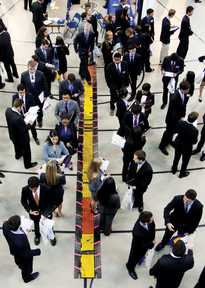 Job searchers wait in line to talk to potential employers at the Career Showcase at the Stephen C. O’Connell Center on Tuesday afternoon.