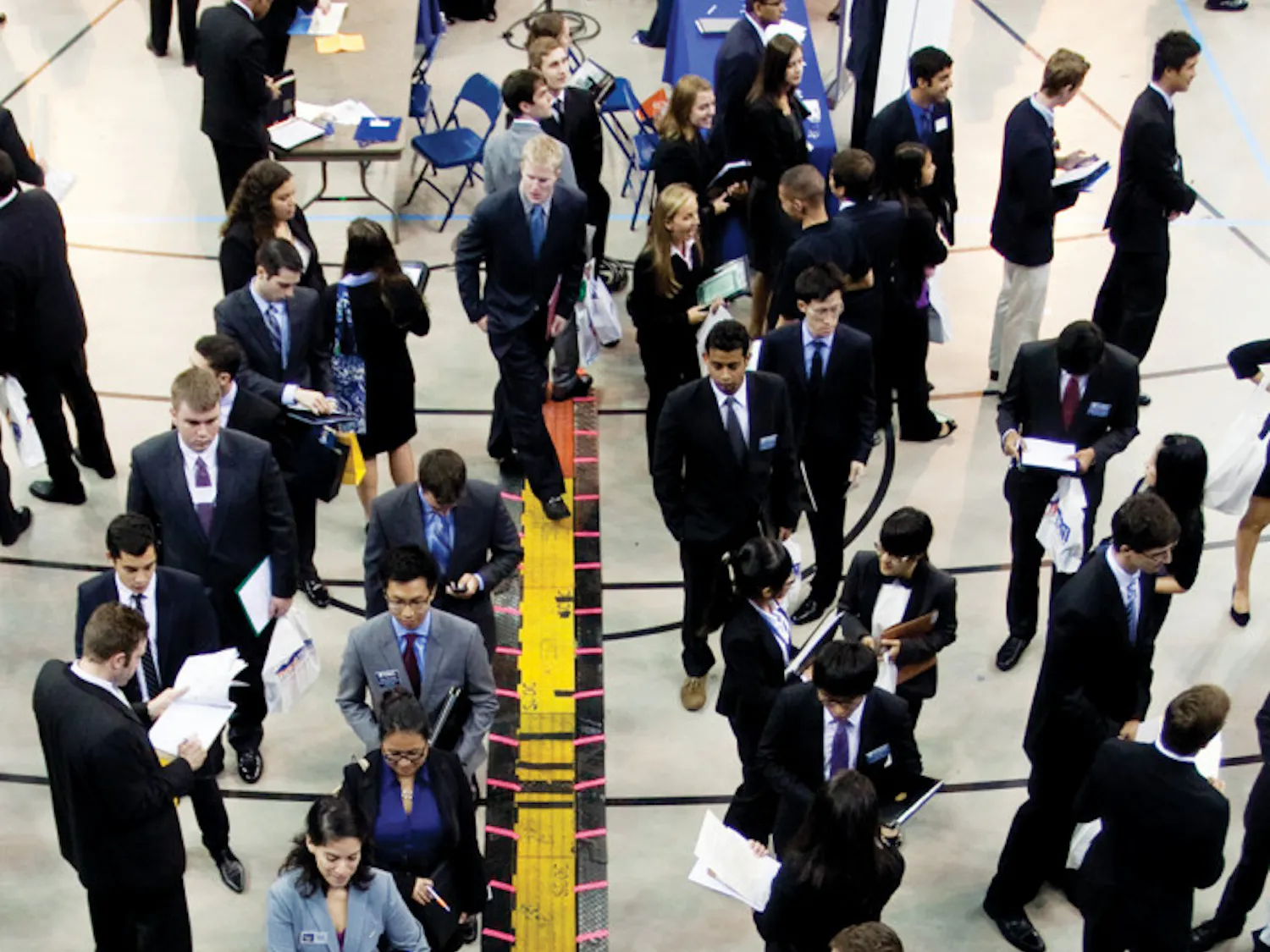 Job searchers wait in line to talk to potential employers at the Career Showcase at the Stephen C. O’Connell Center on Tuesday afternoon.