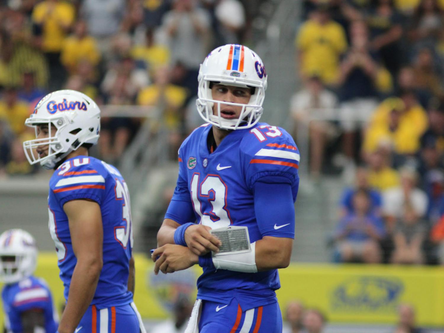 Florida quarterback Feleipe Franks is looking at the sideline for the next play during UF's 33-17 loss to Michigan on Saturday at AT&T Stadium in Arlington, Texas.