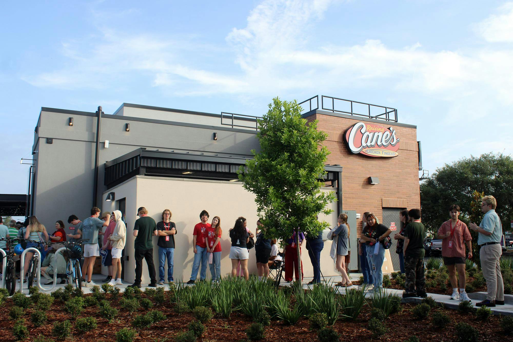 Customers stand in line for the grand opening of Raising Canes located at 12705 NW US HWY 441 in Gainesville, Fla., Wednesday, May 27, 2026.