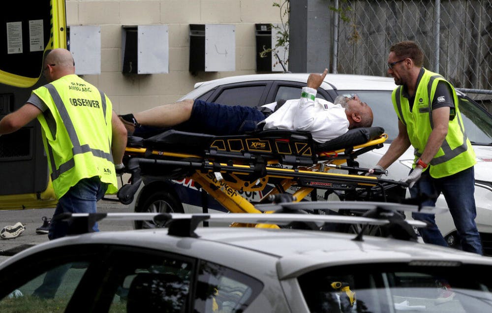 Ambulance staff take a man from outside a mosque in central Christchurch, New Zealand, Friday, March 15, 2019. A witness says many people have been killed in a mass shooting at a mosque in the New Zealand city of Christchurch.(AP Photo/Mark Baker)