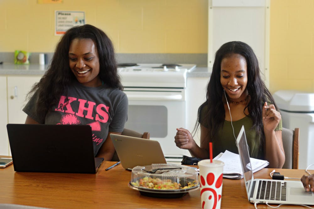 Chenetrice Simpson, 19, and Orchid Thomas, 20, talk and study in the second floor lounge of Graham Hall, where the Black Cultural Living Learning Community is located. 