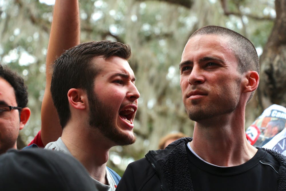 Thomas Moseley, a 20-year-old UF telecommunication junior, shouts at 34-year-old Michael Dewitz (right) on Turlington Plaza on Thursday morning. Dewitz was later attacked after leaving campus. 