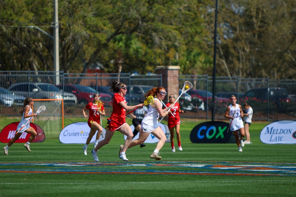 Florida midfielder Madison Waters carries the ball in her crosse in the Gators' 14-13 loss to the No. 6 Maryland Terrapins Saturday, Feb. 25, 2023.