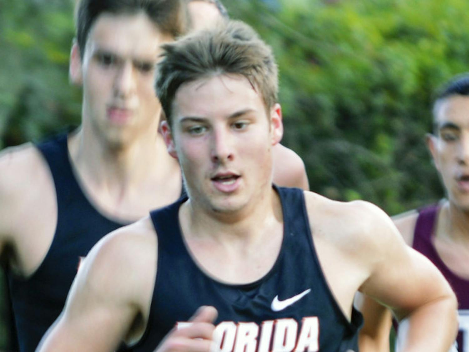 Jimmy Clark races during the 2013 Southeastern Conference Cross Country Championships at the Mark Bostick Golf Course