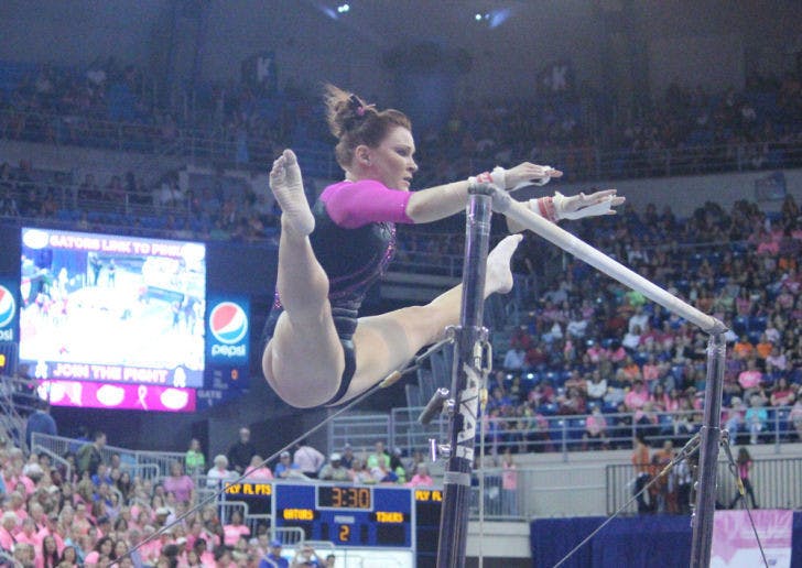 Bridget Sloan performs on the uneven bars during UF’s 198.125 - 197.625 win over LSU during on Feb. 21. Sloan was named the 2014 NCAA uneven bars champion during individual competition Sunday.