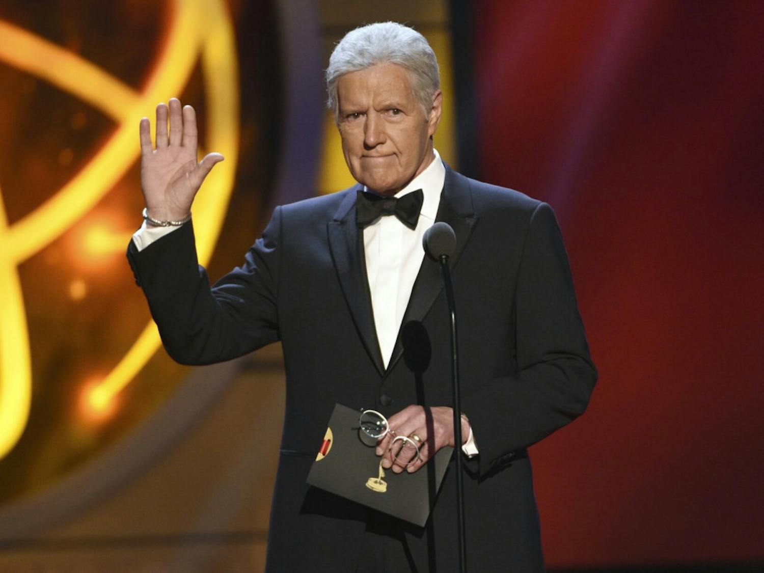 This May 5, 2019, file photo shows Alex Trebek gestures while presenting an award at the 46th annual Daytime Emmy Awards in Pasadena, Calif. Jeopardy!” host Alex Trebek died Sunday, Nov. 8, 2020, after battling pancreatic cancer for nearly two years. Trebek died at home with family and friends surrounding him, “Jeopardy!” studio Sony said in a statement. Trebek presided over the beloved quiz show for more than 30 years.