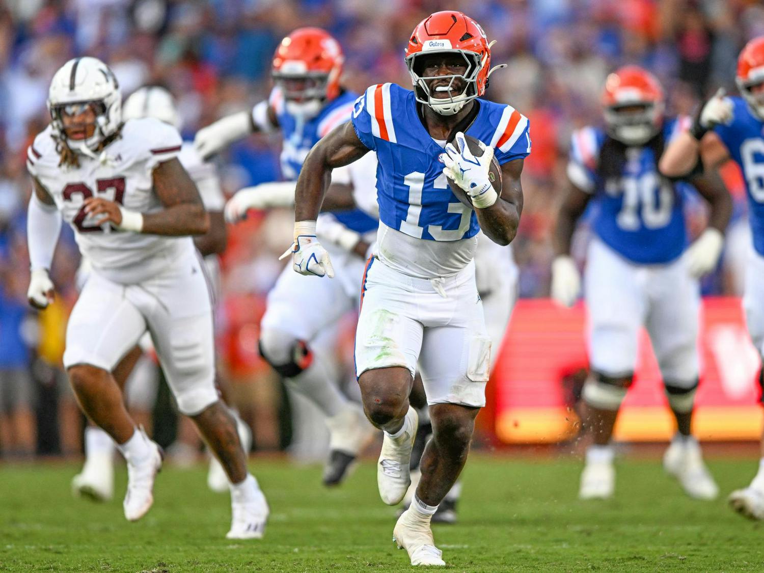 Florida Gators running back Jadan Baugh (13) runs with the ball in a NCAA college football game, Saturday, Oct. 18, 2025, in Gainesville, Fla.