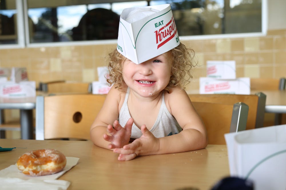Tessa Reed, 2, smiles after eating a donut on Monday morning during the “International Talk Like a Pirate Day” at Krispy Kreme. Throughout the day, anyone who dressed up like a pirate received a free box of donuts.