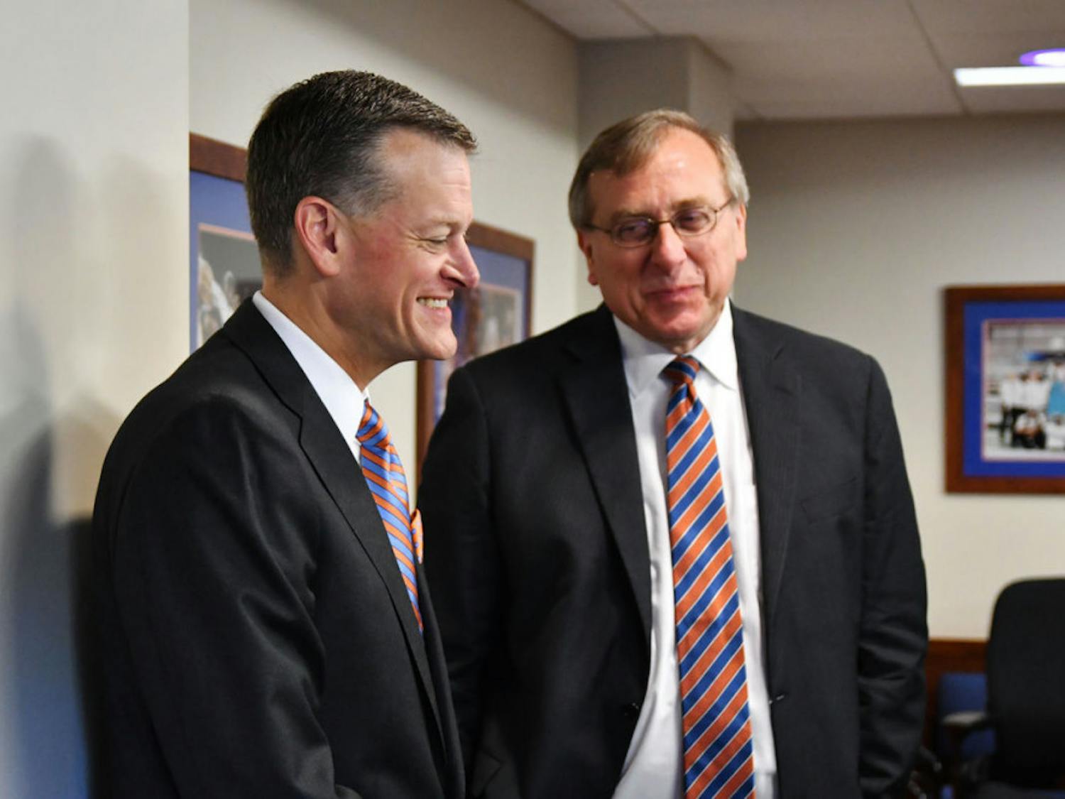 UF athletic director Scott Stricklin talks with president Kent Fuchs during Florida's search committee meeting on Sept. 27, 2016, at the Kelly Smith Conference Room.