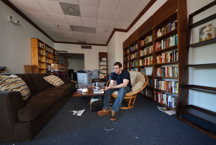 David Merahn, 26, works to prepare Broken Shelves bookstore for Friday’s soft opening. Merahn said he wants to create a place where creative and engaging minds can hang out and socialize.