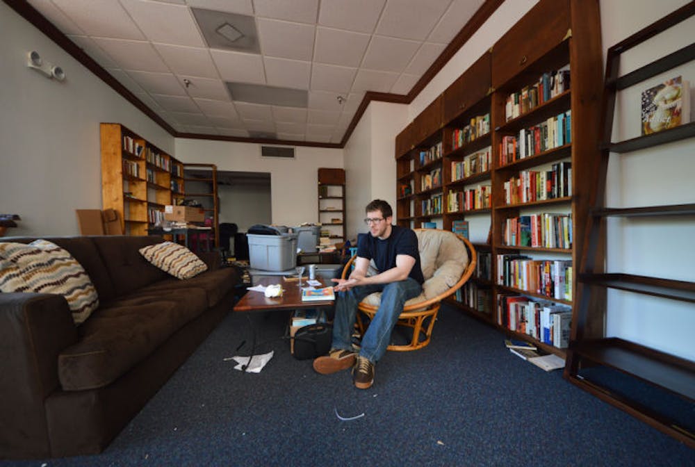 <p>David Merahn, 26, works to prepare Broken Shelves bookstore for Friday’s soft opening. Merahn said he wants to create a place where creative and engaging minds can hang out and socialize.</p>