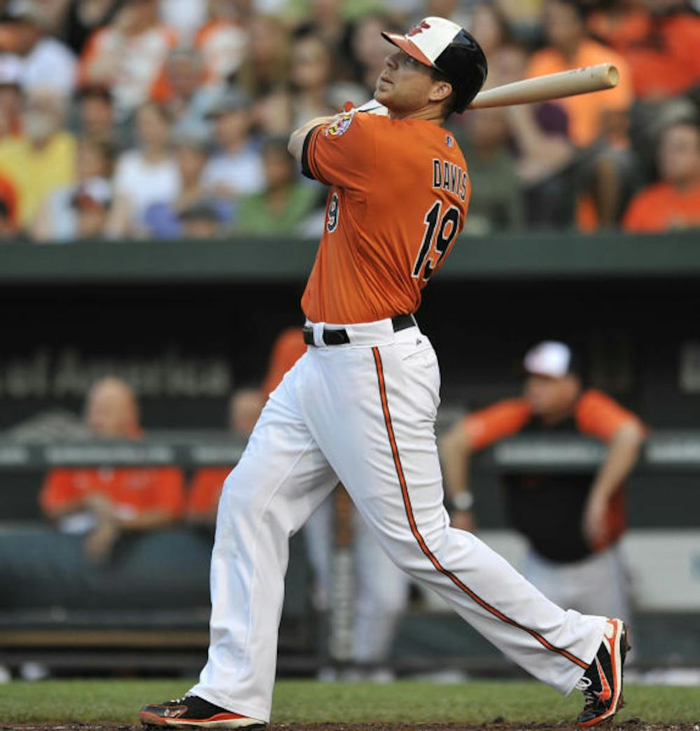 <p>Baltimore’s Chris Davis follows through on a three-run home run against the New York Yankees on June 29 in Baltimore. Davis is the American League’s starting first baseman.</p>