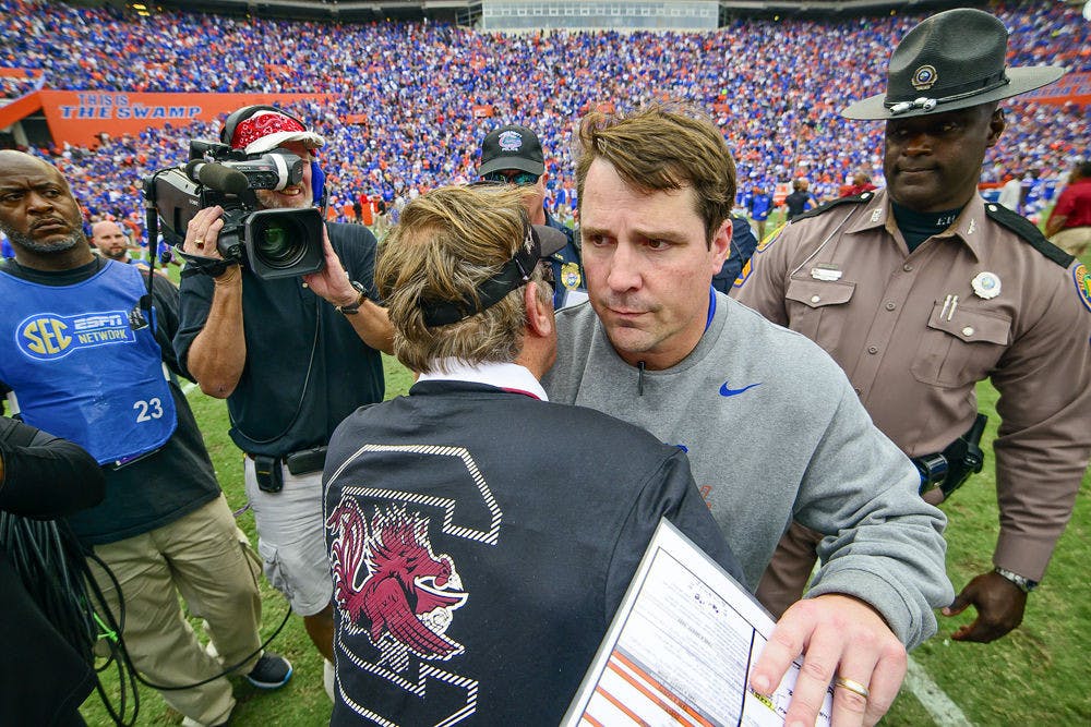 <p>Florida coach Will Muschamp and South Carolina coach Steve Spurrier shake hands following the Gators' 23-20 overtime loss to the Gamecocks on Saturday at Ben Hill Griffin Stadium.</p>