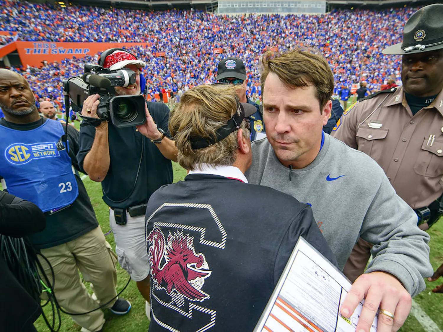 Florida coach Will Muschamp and South Carolina coach Steve Spurrier shake hands following the Gators' 23-20 overtime loss to the Gamecocks on Saturday at Ben Hill Griffin Stadium.