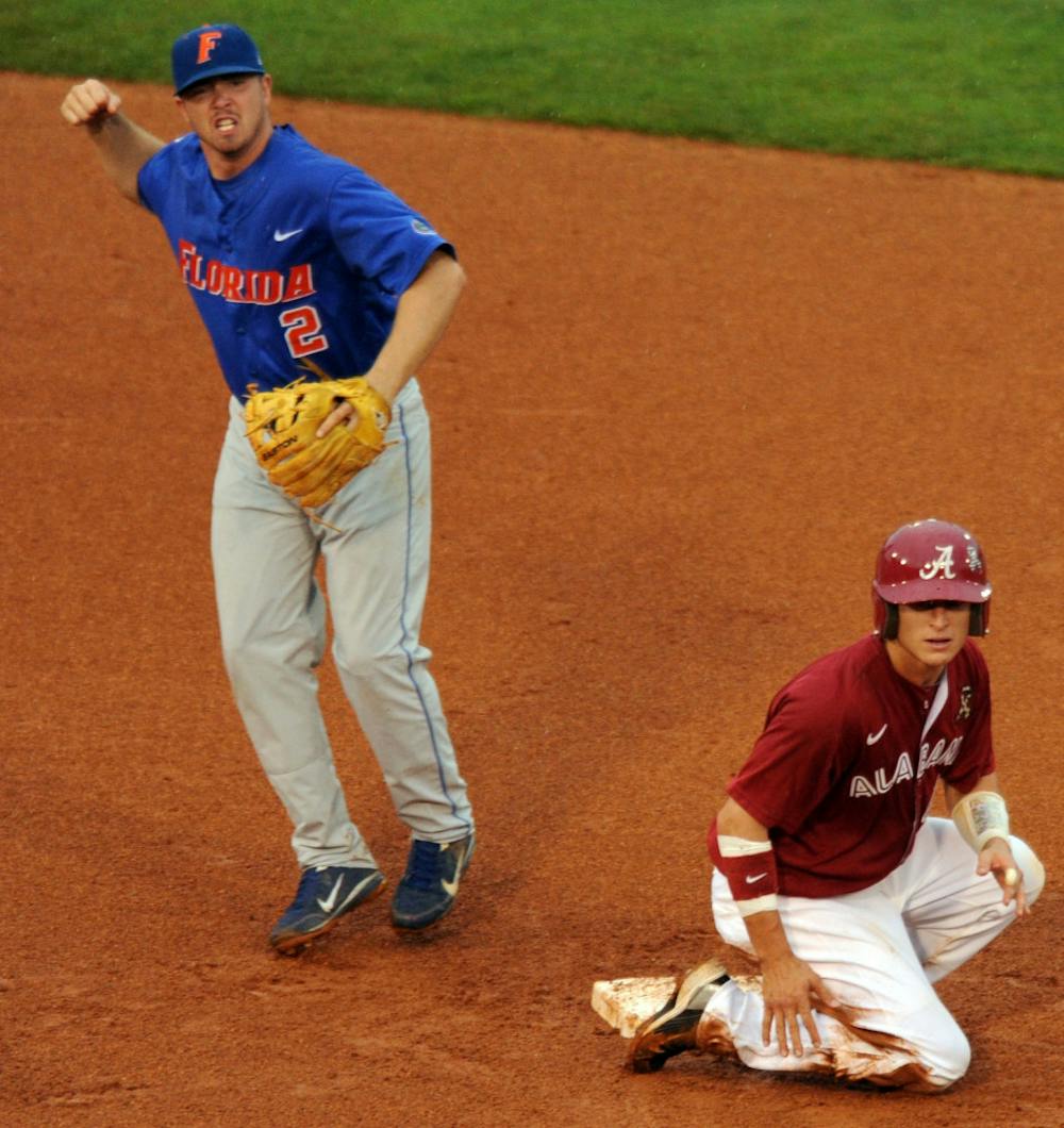 Florida senior second baseman Josh Adams pumps his fist as his throw over Alabama's Brock Bennett completes one of UF's three double plays in the Gators 6-0 shutout over the Crimson Tide in Thursday's SEC Tournament contest in Hoover, Ala.