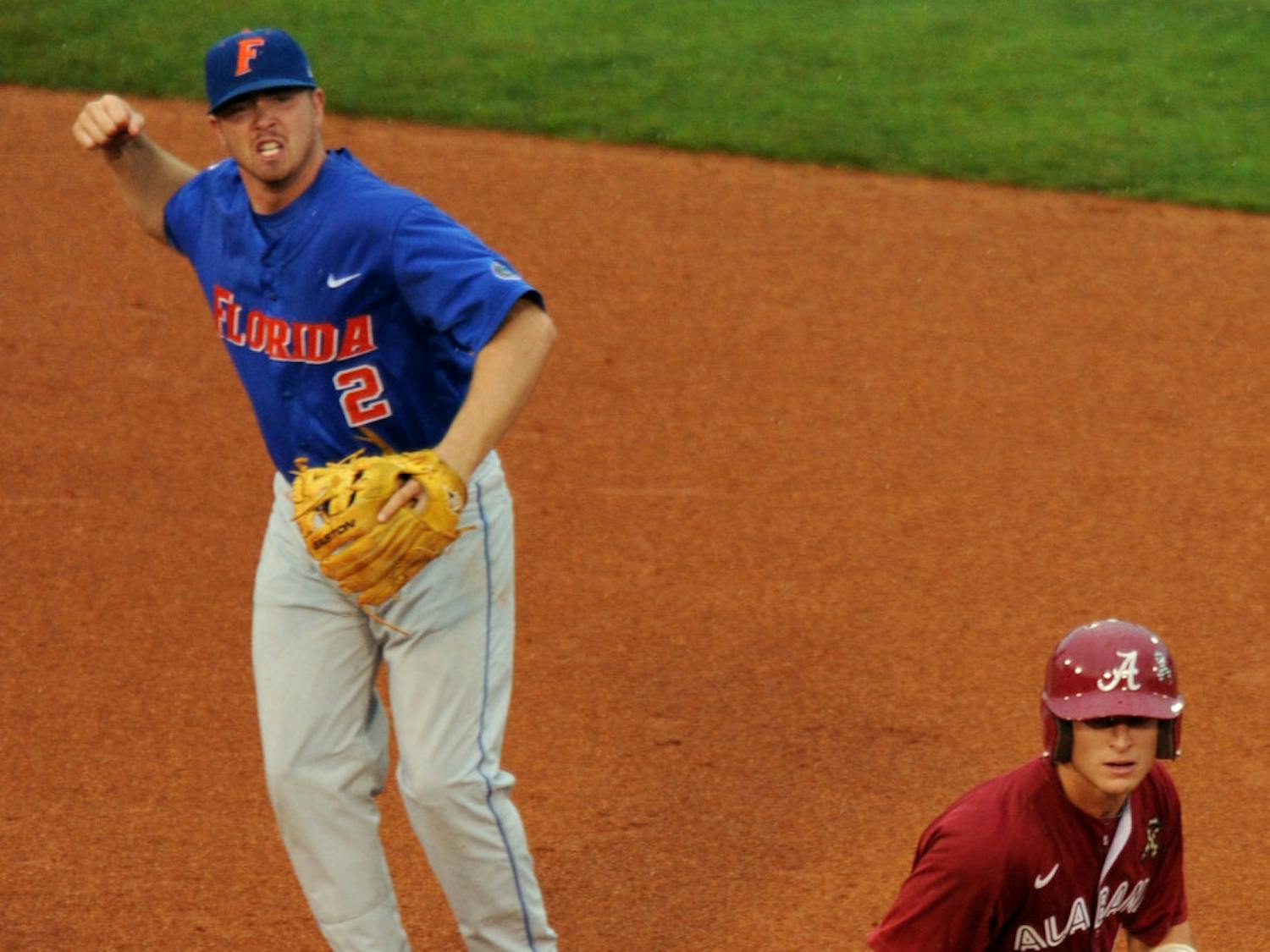 Florida senior second baseman Josh Adams pumps his fist as his throw over Alabama's Brock Bennett completes one of UF's three double plays in the Gators 6-0 shutout over the Crimson Tide in Thursday's SEC Tournament contest in Hoover, Ala.