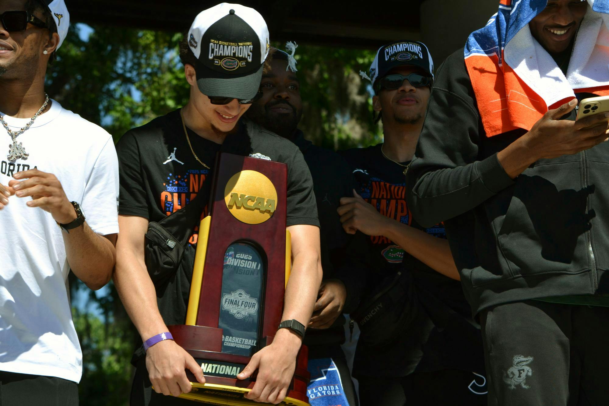 UF senior guard Walton Clayton Jr. holds the national championship trophy at Flavet Field in Gainesville, Fla. on Tuesday, April 8, 2025. The UF men's basketball team returned home following their win against Houston in NCAA Men's Basketball National Championship on Monday, April 7, 2025 in San Antonio. 