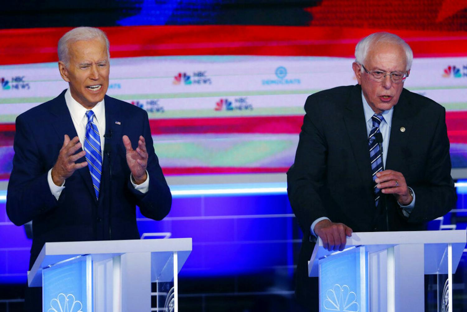 FILE - In this June 27, 2019, file photo, Democratic presidential candidates, former Vice President Joe Biden and Sen. Bernie Sanders, I-Vt., speak at the same time during the Democratic primary debate hosted by NBC News at the Adrienne Arsht Center for the Performing Arts in Miami. What might be the final showdown between the two very different Democratic candidates takes place Tuesday, March 17, 2020, during Florida's presidential primary. (AP Photo/Wilfredo Lee, File)
