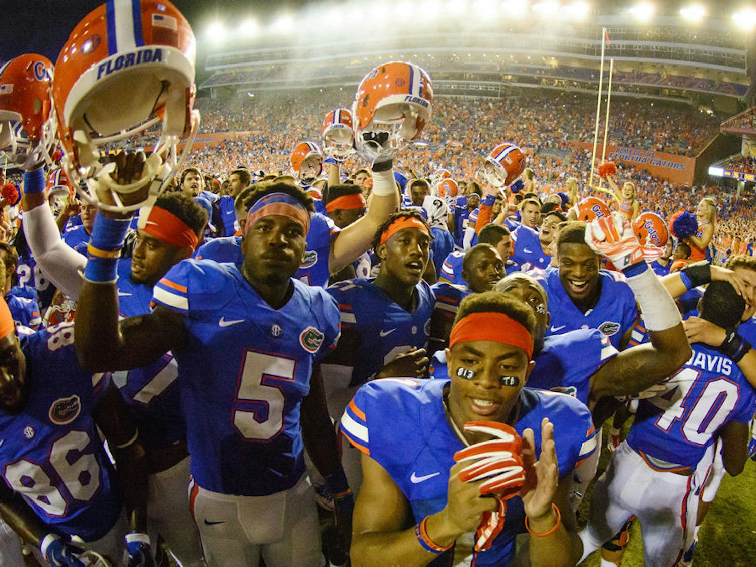 UF football players celebrate following Florida's 36-30 triple-overtime win against Kentucky on Sept. 13 at Ben Hill Griffin Stadium.
