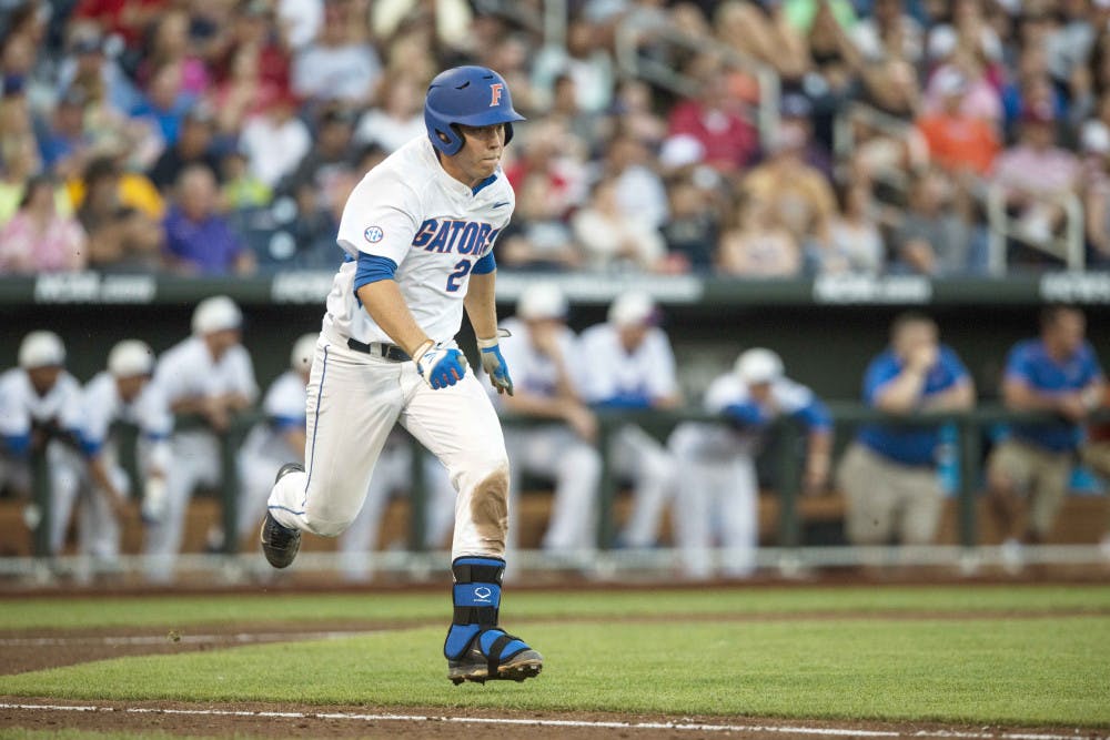 <p>Florida's JJ Schwarz (22) runs toward first base during the Gators' 15-3 victory against Miami in the NCAA Men's College World Series on Saturday, June 13, 2015 at the TD Ameritrade Park in Omaha.</p>