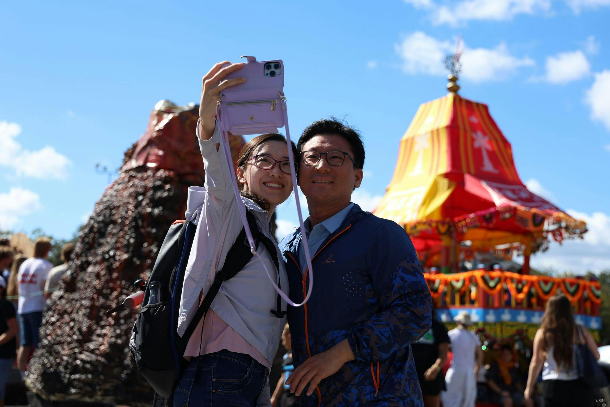 Xue and Yusen Zhai pose for a selfie in front of parade floats just before the UF Homecoming Parade on Friday, Oct. 17, 2025. 
