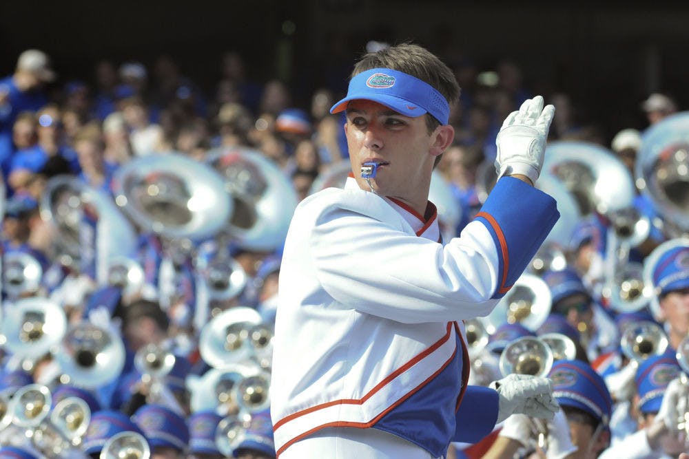 <p>Ben Judkins conducts the Gator Band during UF’s 38-10 win against Ole Miss on Oct. 3, 2015,&nbsp;at Ben Hill Griffin Stadium. The drum major has directed the 350-student band, along with two other drum majors, for two years.</p>