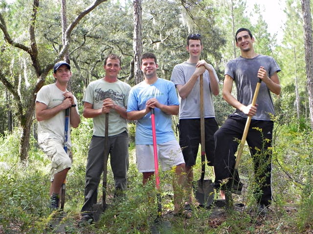 Jacob Cravey, 30; Ivor Kincaide, 38; Christopher Wolf, 25; Alex Potts, 25; and David Hanan, 24, planted aroundtrees Friday morning at Paynes Prairie as part of a project with Neutral Gator.