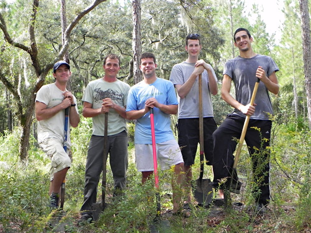 <p>Jacob Cravey, 30; Ivor Kincaide, 38; Christopher Wolf, 25; Alex Potts, 25; and David Hanan, 24, planted aroundtrees Friday morning at Paynes Prairie as part of a project with Neutral Gator.</p>