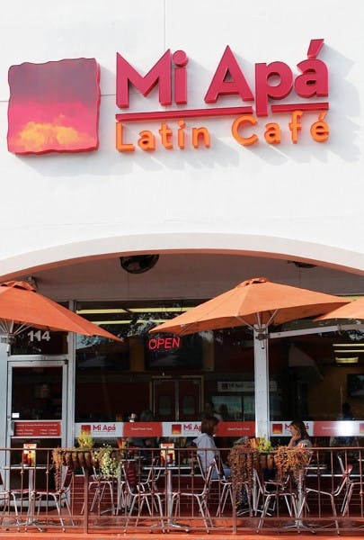 Patrons Tammy Bernard, left, and Jenny Lee, right, eat a meal outside Mi Apa Latin Cafe on 34th Street. The cafe will open a second location Monday in Alachua at 15634 NW Highway 441.