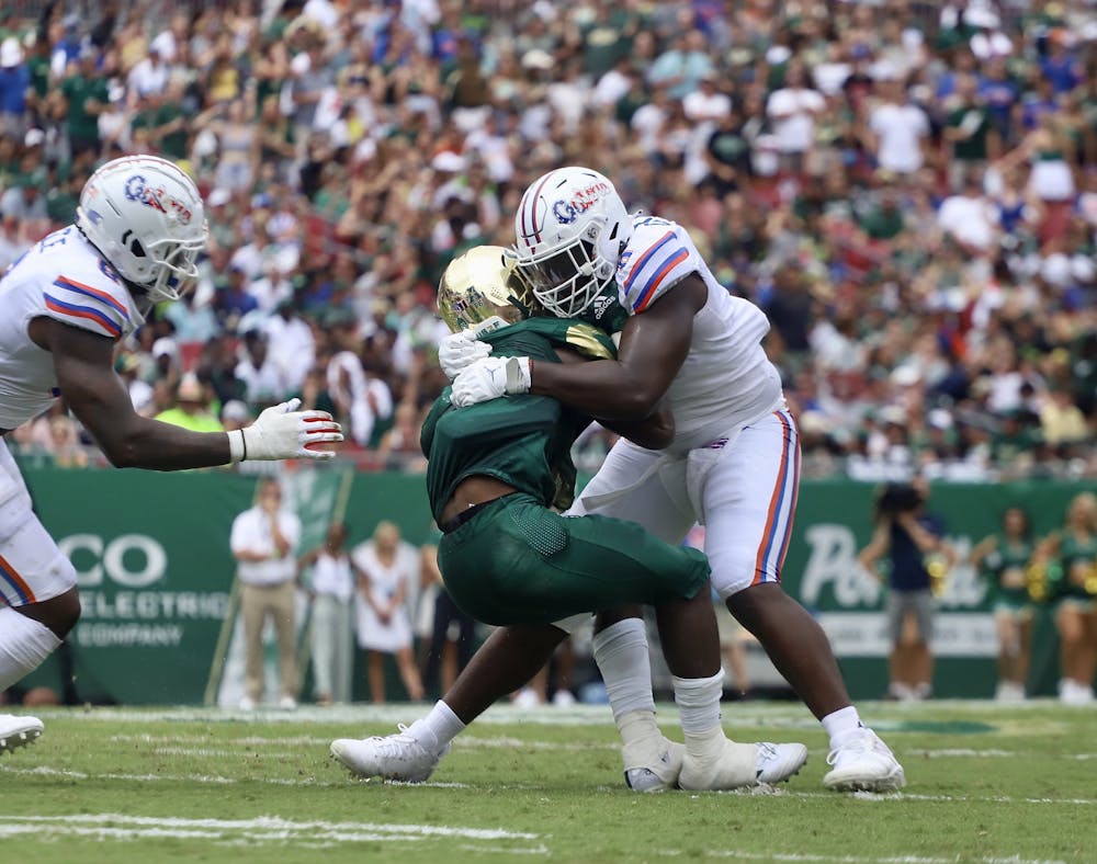 <p>Florida defensive end Zachary Carter tackles a USF ball carrier on Sept. 11. Carter will look to add to his three sacks this season this Saturday versus Alabama. </p>
