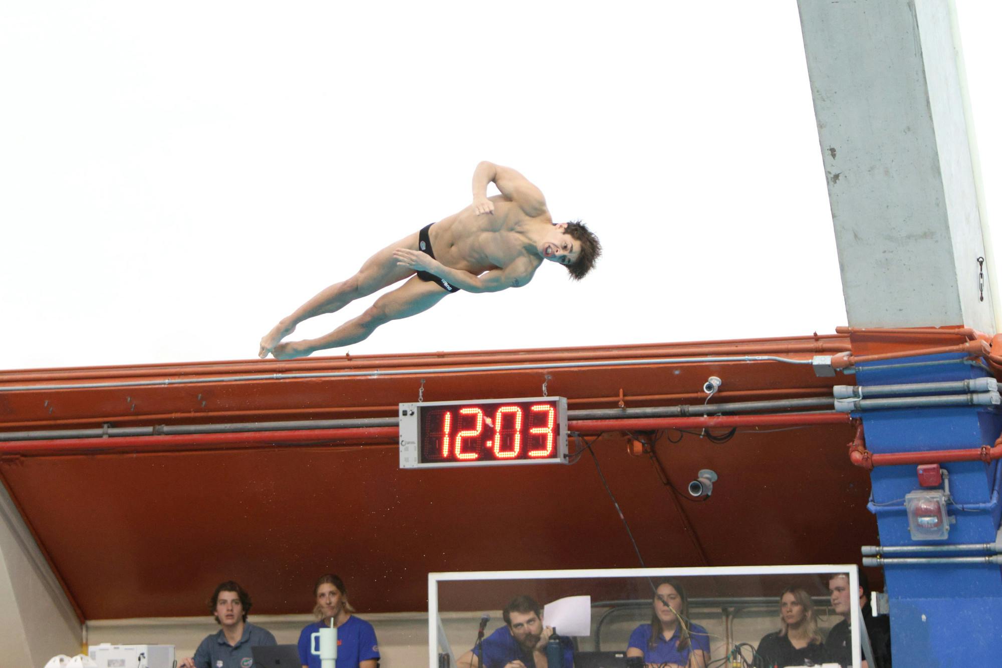 Freshman Conor Gesing dives in the Gators meet against Florida State, Friday, Jan. 26, 2024.