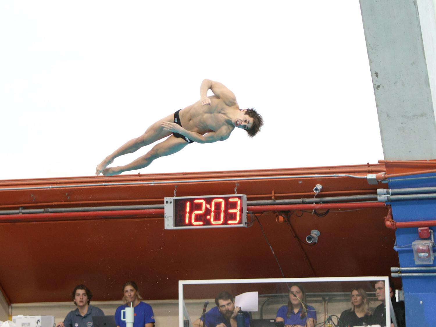 Freshman Conor Gesing dives in the Gators meet against Florida State, Friday, Jan. 26, 2024.