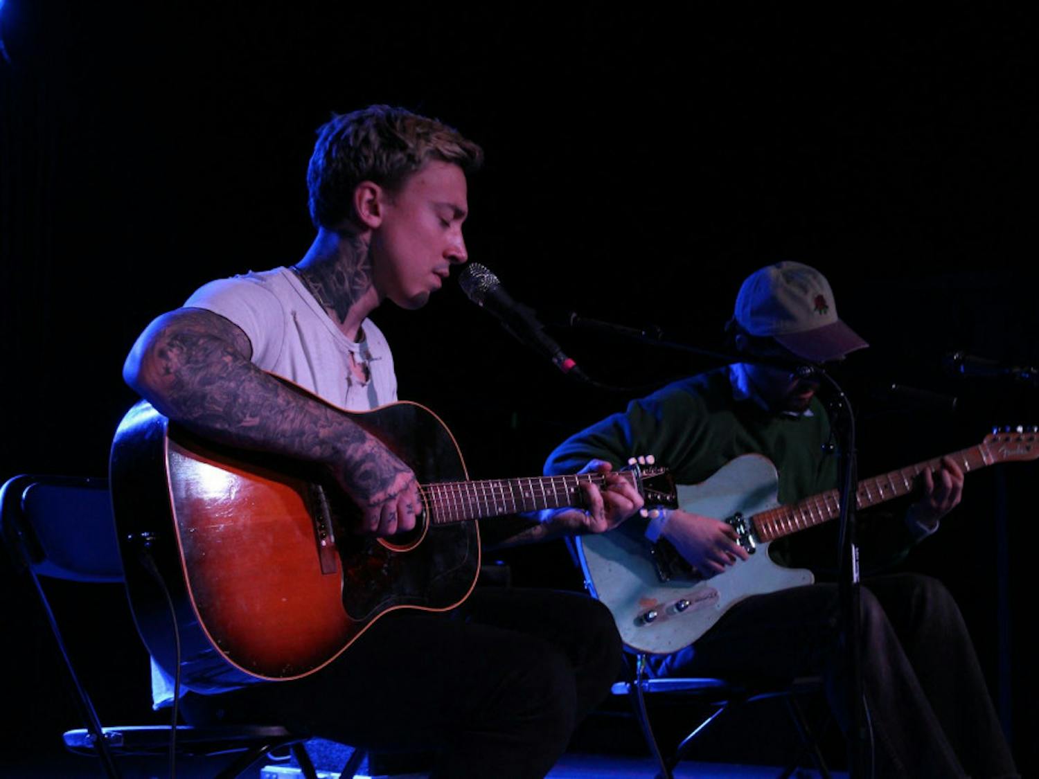 Musicians Noah Gundersen (left) and Harrison Whitford (right) collaborate during an acoustic performance on Sunday.