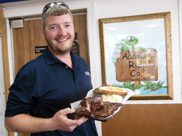 Gainesville native, Adam Brewer, shows off his pride and joy: perfect BBQ ribs.