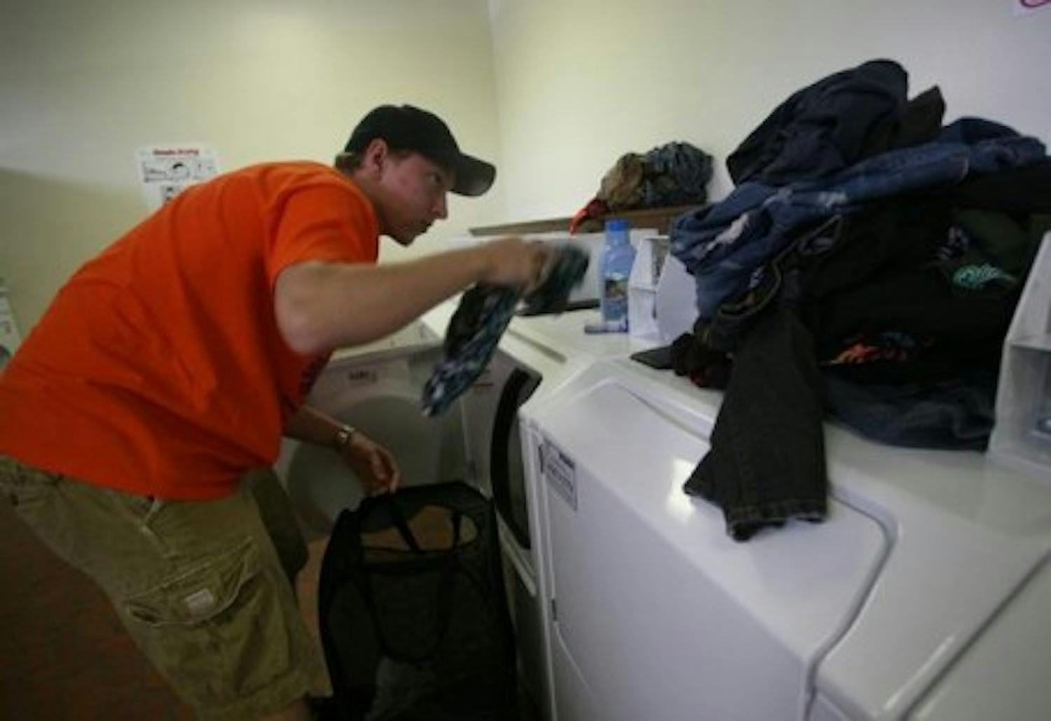 UF sophomore Chris Saunders separates his dark from his light clothes in the laundry room of Beaty Towers West on Thursday, Sept. 7, 2007.