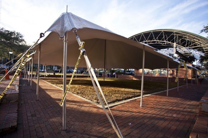 Technical problems have forced the abandonment of efforts to construct an ice rink downtown on Bo Diddley Plaza. The white tarp pitched above the plaza's grassy pit was the only remnant from the rink Sunday afternoon.