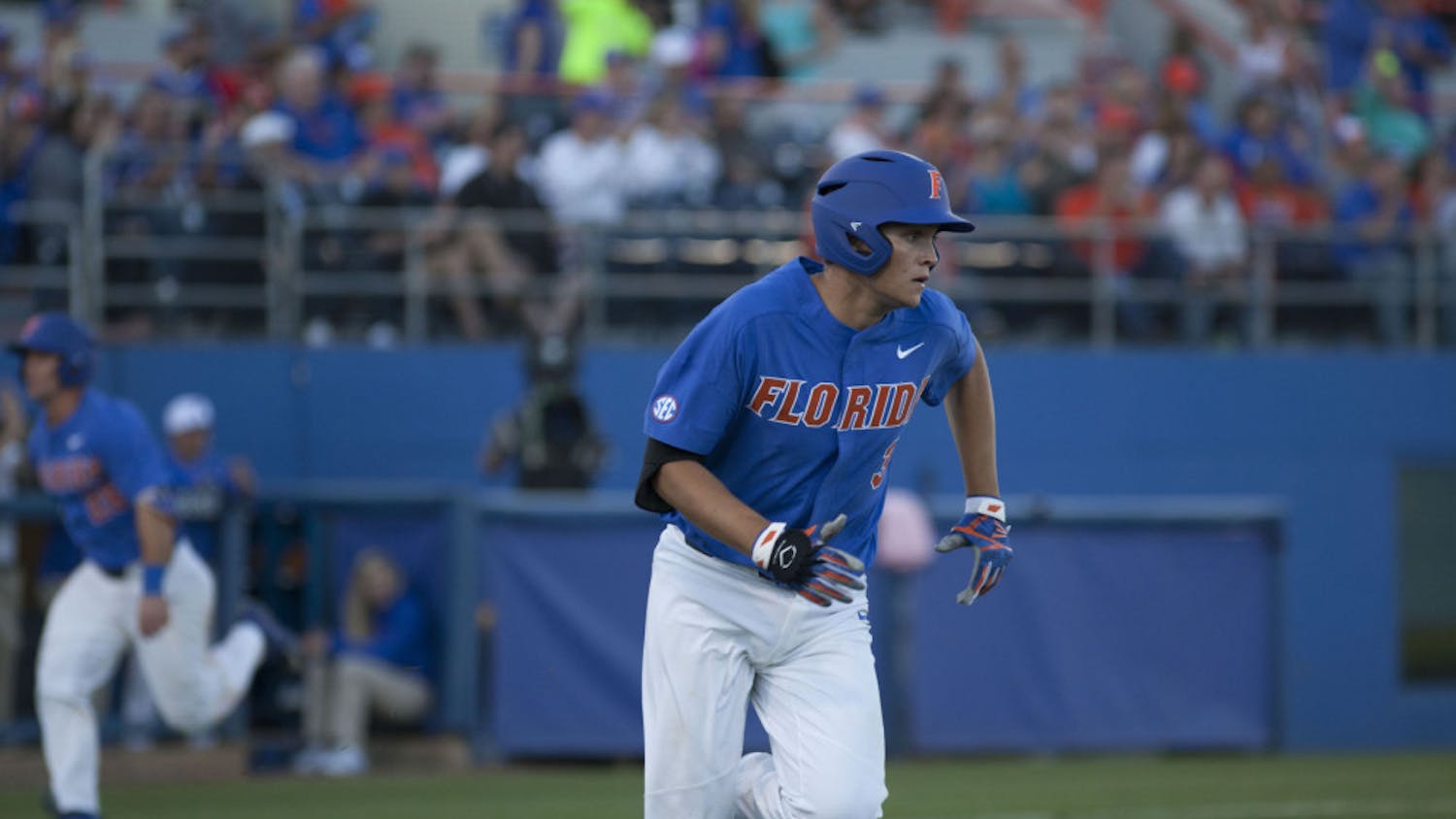 UF infielder/pitcher Garrett Milchin runs towards first base after getting a hit during Florida&#x27;s 3-2 loss against Tennessee on April 8, 2017, at McKethan Stadium.