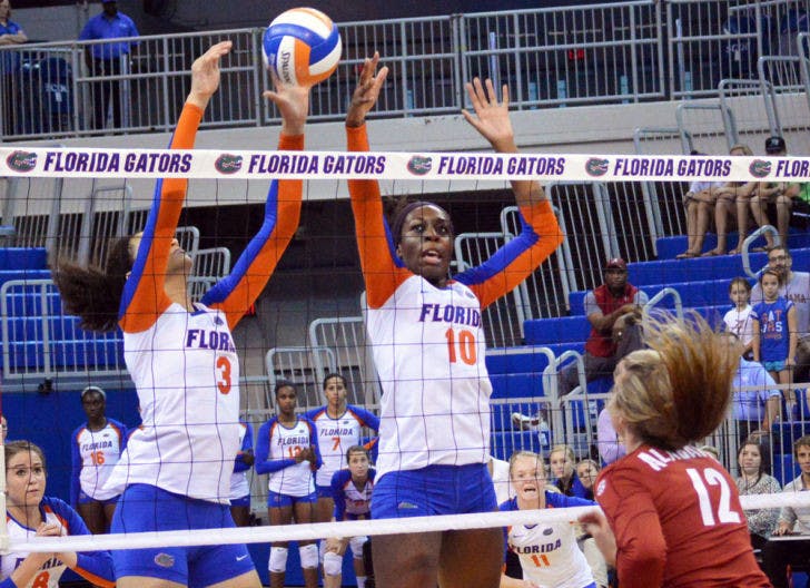 Chloe Mann (10) attempts to block the ball during Florida’s three-set victory against Alabama on Sunday in the O’Connell Center. Mann is hitting .500 this season.