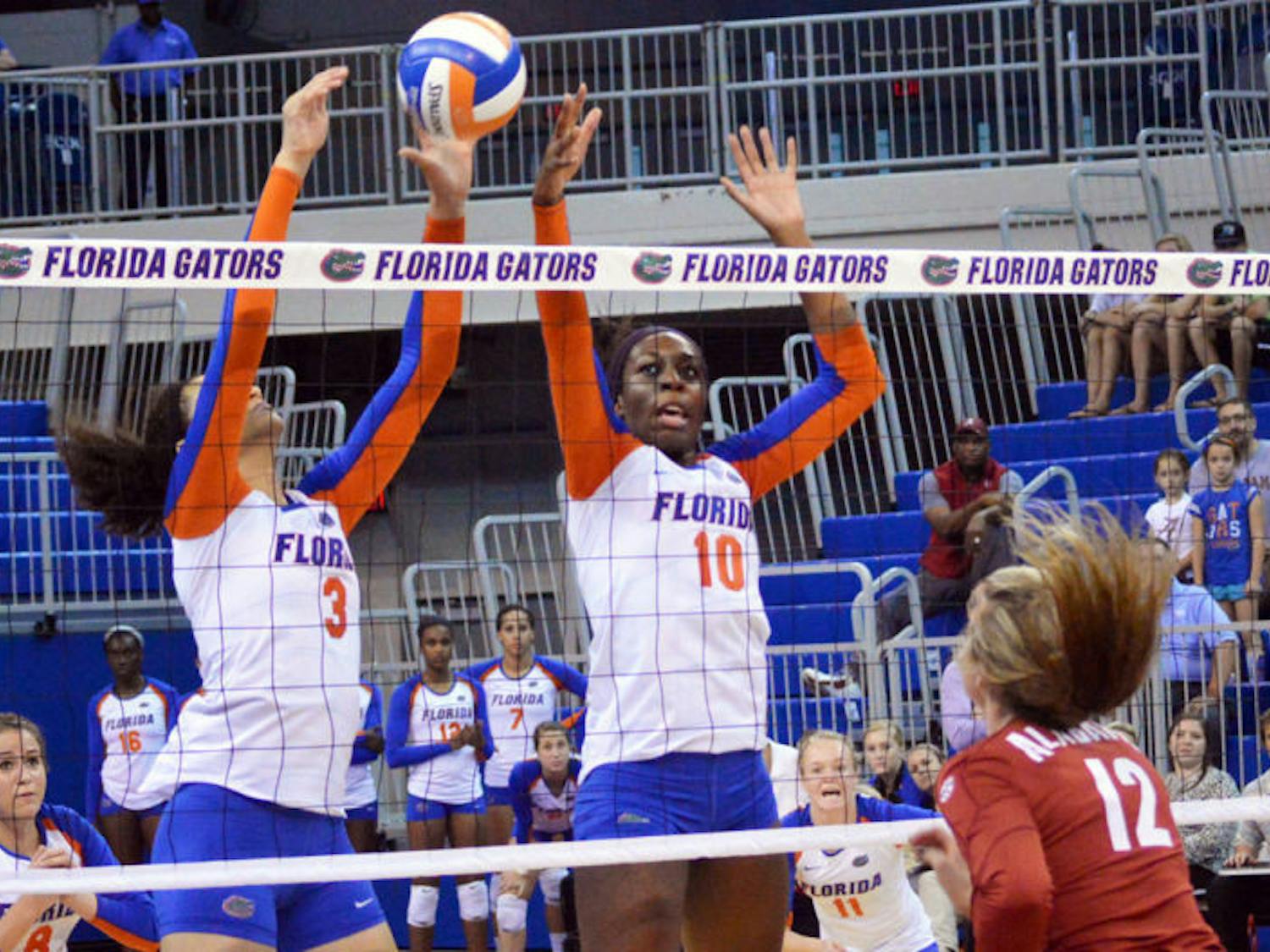Chloe Mann (10) attempts to block the ball during Florida’s three-set victory against Alabama on Sunday in the O’Connell Center. Mann is hitting .500 this season.