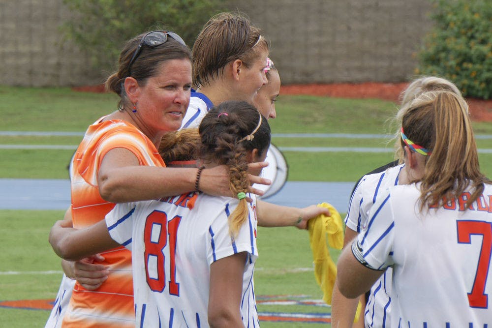 <p>UF soccer coach Becky Burleigh puts her arm around defender Rachelle Smith (81) following Florida's 3-2 win against Florida Sate on Aug. 30, 2015, at James G. Pressly Stadium.</p>