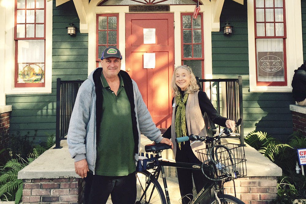 <p>Pictured are “Big Mike,” a graduate of the “Quit Smoking Now” classes held at the Helping Hands Clinic, and Cathy Cook, the “Quit Smoking Now” program coordinator. “Big Mike” was awarded a bicycle for completing the program.</p>