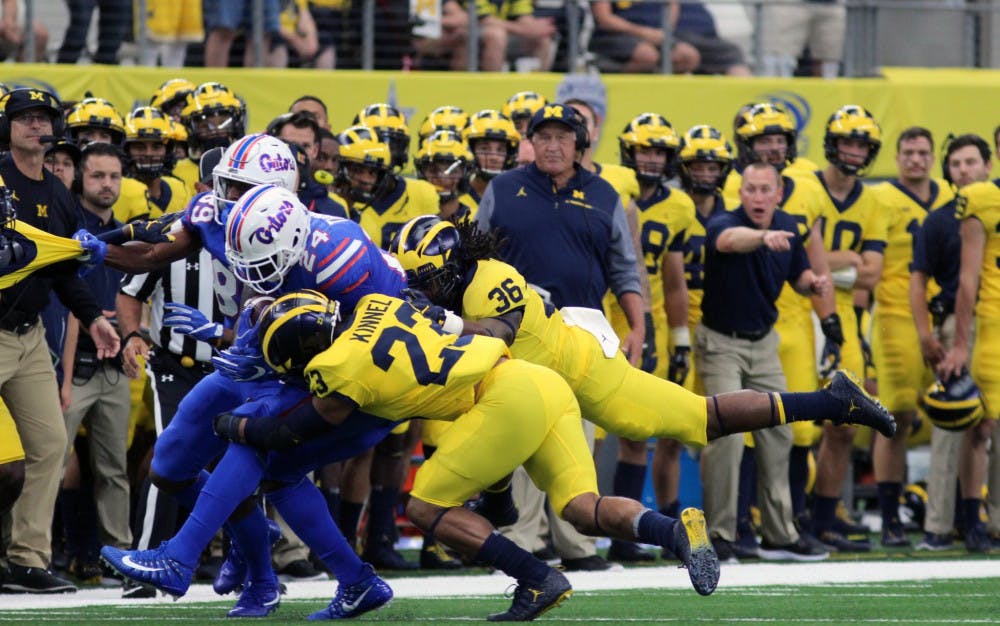 UF running back Mark Thompson (24) gets tackled while running with the ball in Florida's 33-17 loss to Michigan on Saturday in AT&amp;T Stadium in Arlington, Texas.