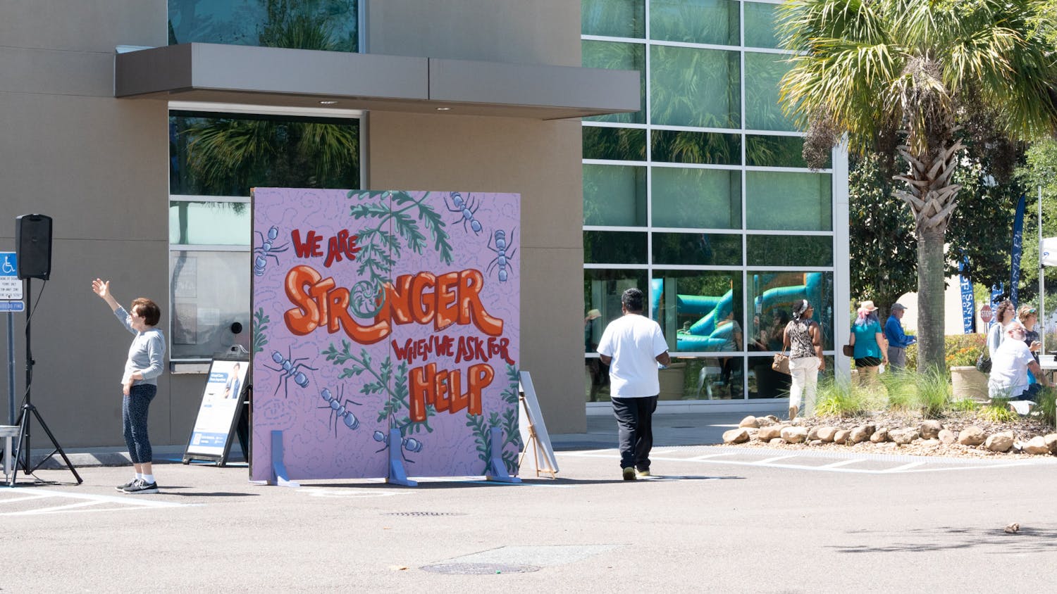 Attendees walk past art displayed at Santa Fe College for the Spring Arts Festival on Sunday, April 14, 2024.