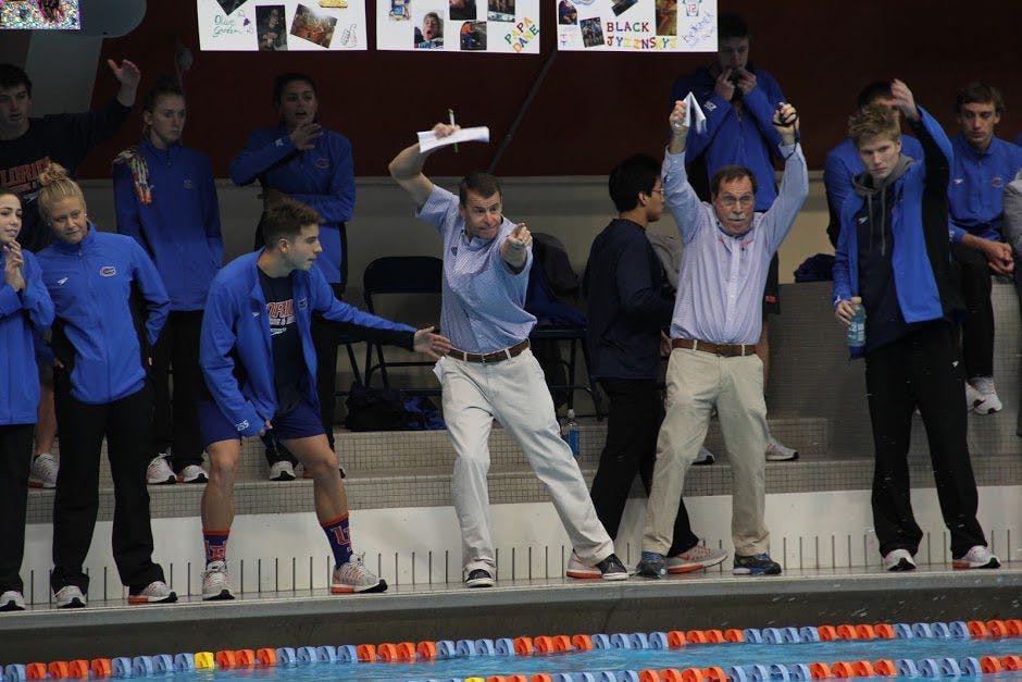 UF head coach Gregg Troy (right) and associate head coach Jeff Poppell (left) celebrate during Florida's 183-117 win against Tennessee on Jan. 28, 2017, in the O'Connell Center.