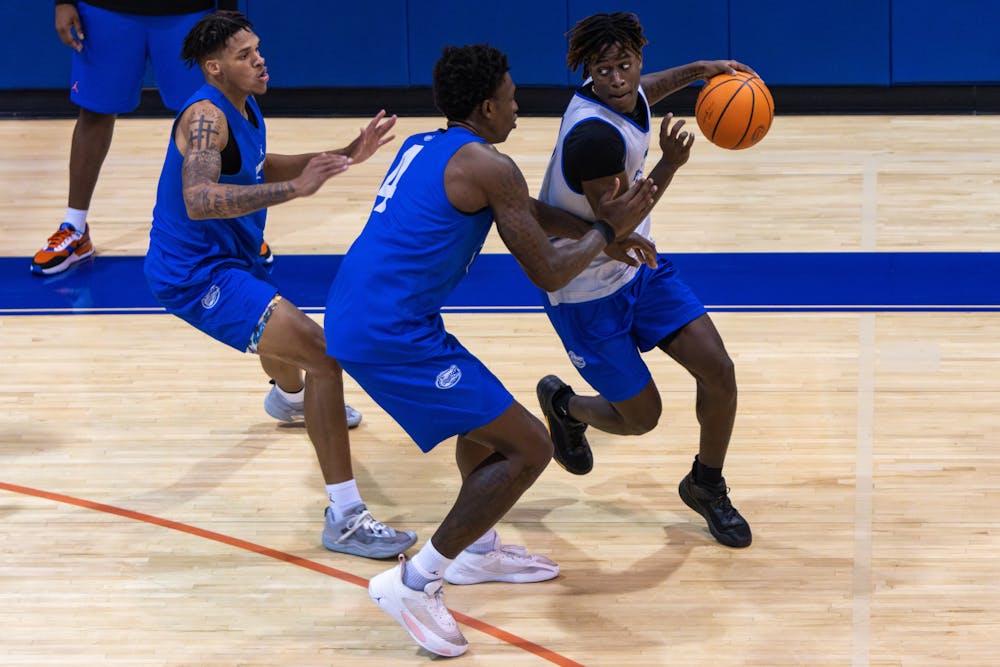 Sophomore guard Denzel Aberdeen goes against two defenders in the Gators’ open practice on Tuesday, Sept. 26, 2023.  