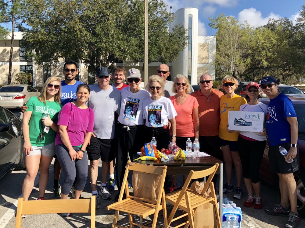 <p>Participants pose for a photo Saturday at the first Walk with a Doc event. The group will meet every other Saturday to build relationships between patients and physicians and promote healthy living.</p>